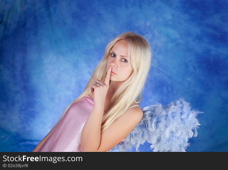 Beautiful girl posing on a blue background. Beautiful girl posing on a blue background