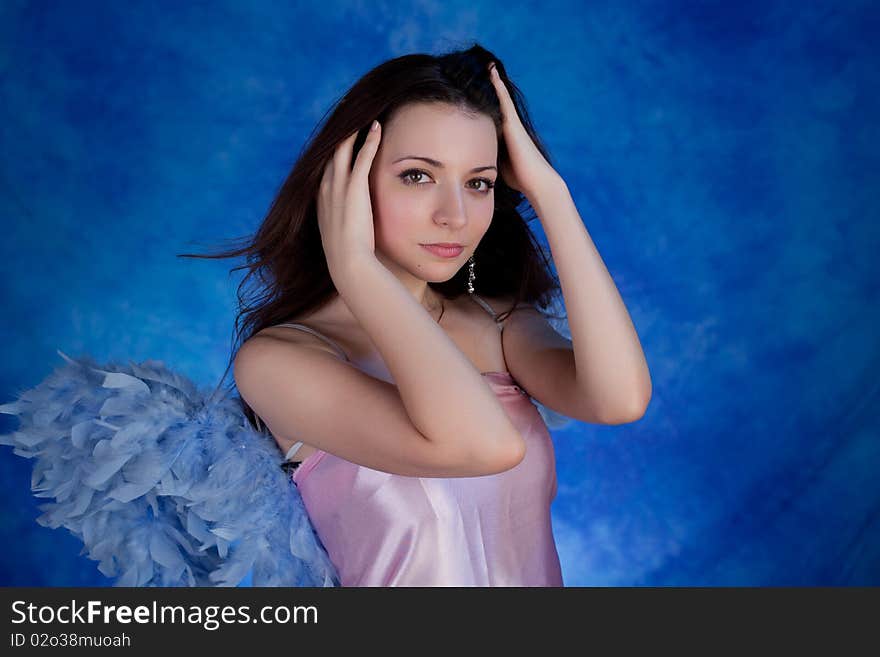 Beautiful girl posing on a blue background. Beautiful girl posing on a blue background