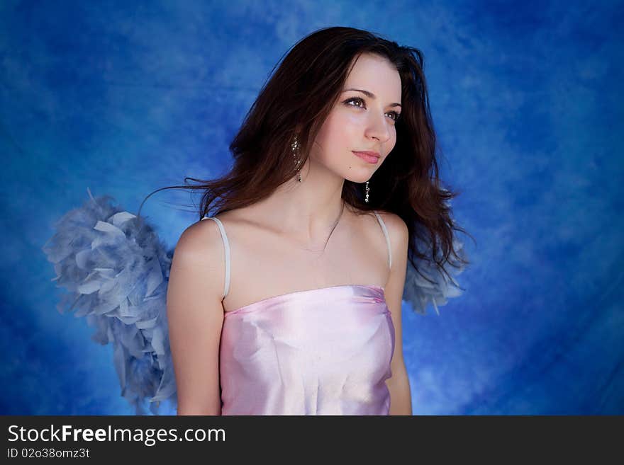 Beautiful girl posing on a blue background. Beautiful girl posing on a blue background