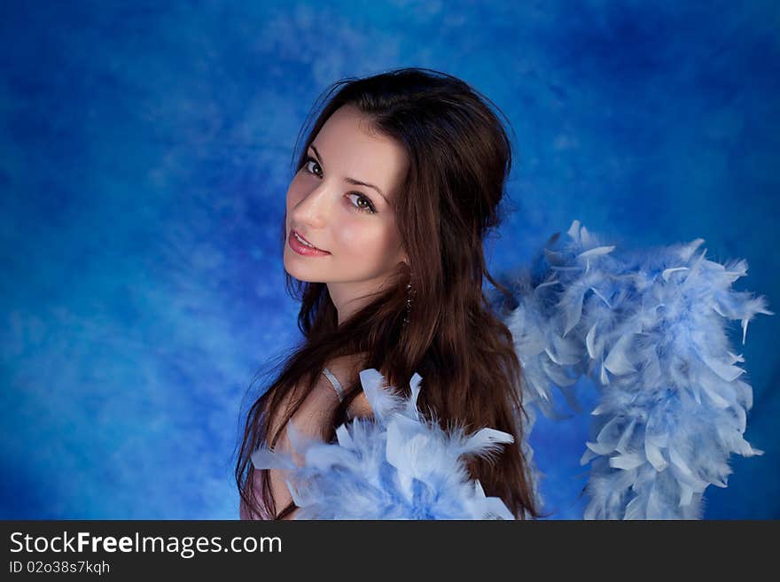 Beautiful girl posing on a blue background. Beautiful girl posing on a blue background