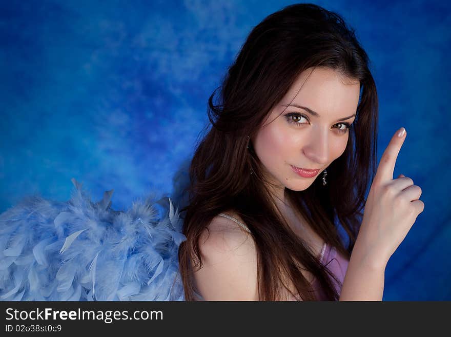 Beautiful girl posing on a blue background. Beautiful girl posing on a blue background