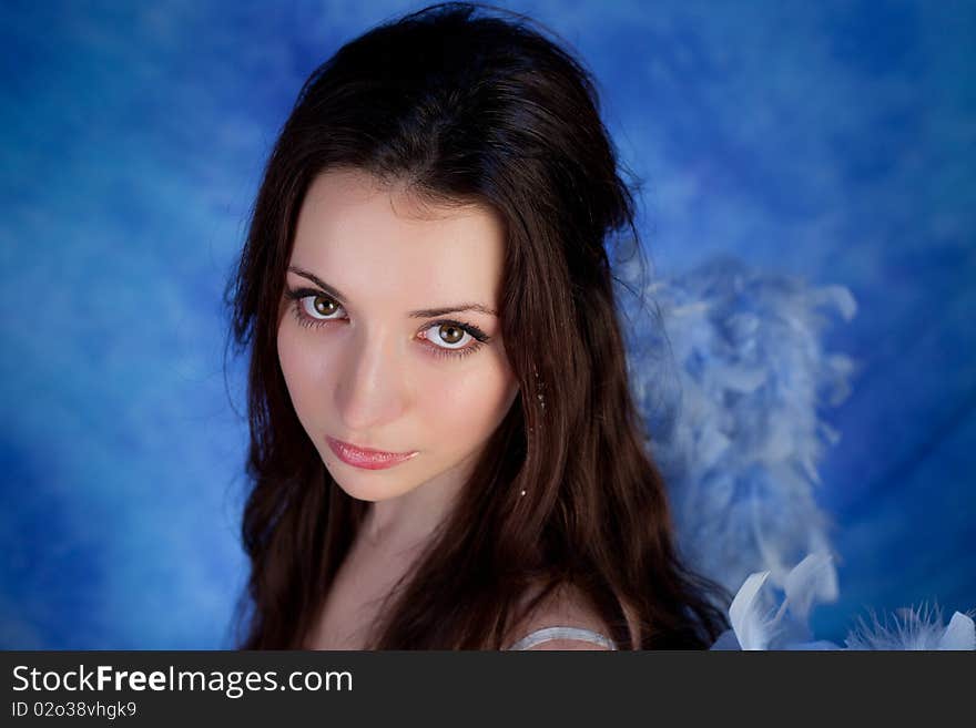 Beautiful girl posing on a blue background. Beautiful girl posing on a blue background