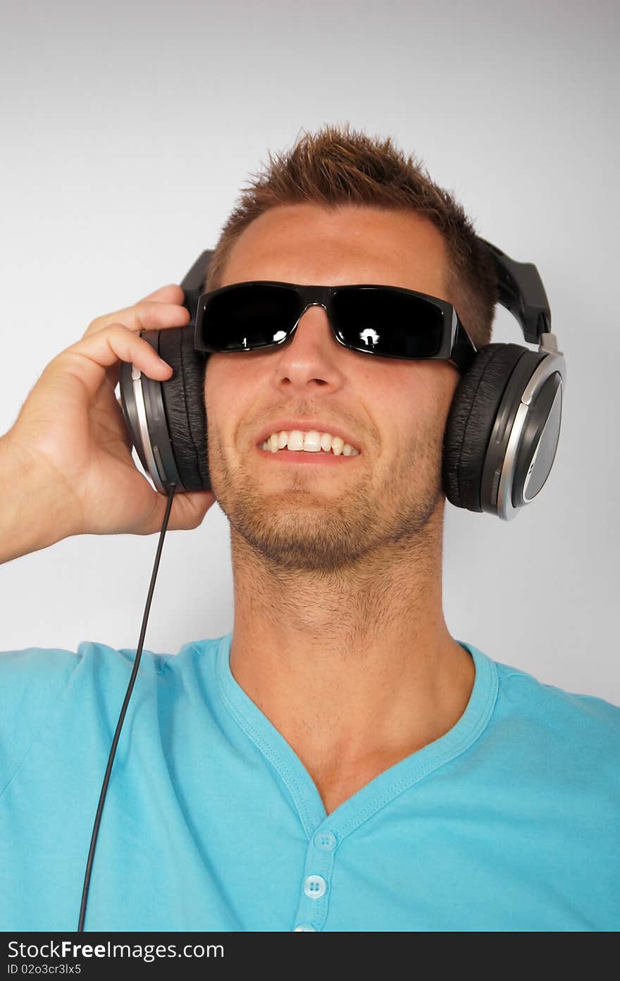 Portrait of young man with headphones, smiling happy. Portrait of young man with headphones, smiling happy.