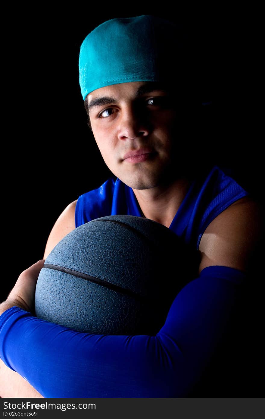 Young teenage basketball player in a studio setting with hip athletic clothing. Young teenage basketball player in a studio setting with hip athletic clothing.