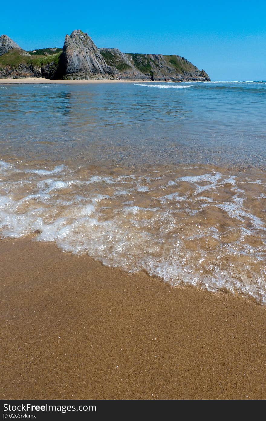 Waves breaking on the coastline at the beach on a summer's day. Waves breaking on the coastline at the beach on a summer's day