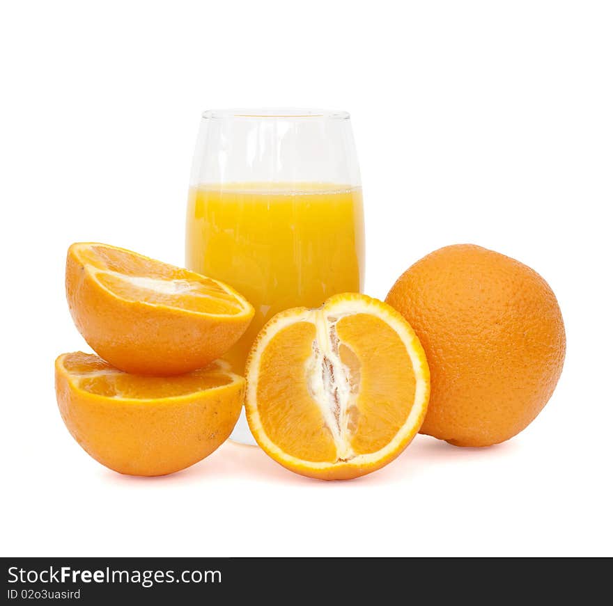 Glass of orange juice and oranges on white background