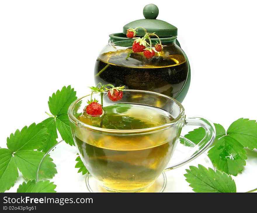 Herbal tea with with wild strawberry in cup and teapot. Herbal tea with with wild strawberry in cup and teapot