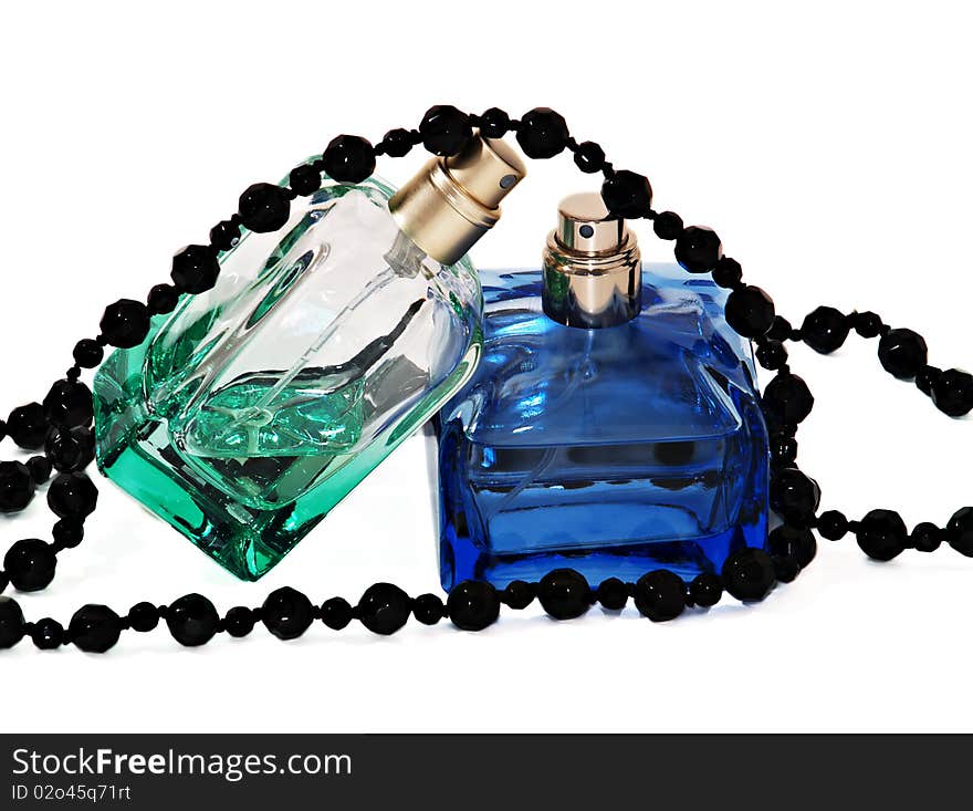 Two pulverizers with perfume and black necklace