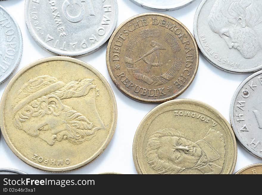 Different metal coins over white