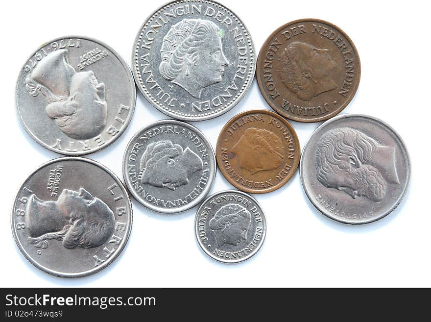 Different metal coins over white