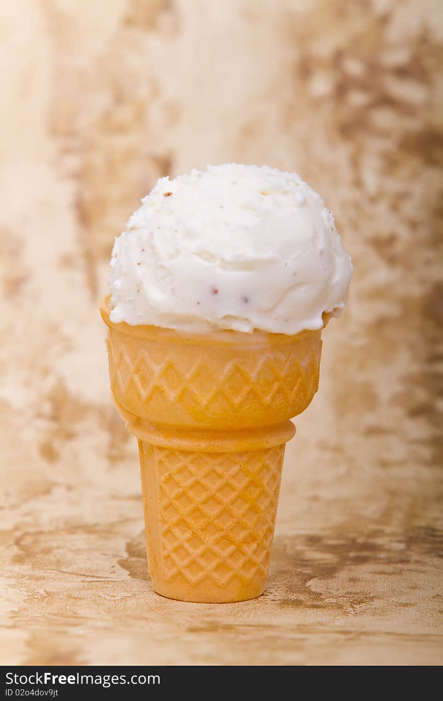 Scoop of vanilla ice cream in ice cream cone. Scoop of vanilla ice cream in ice cream cone