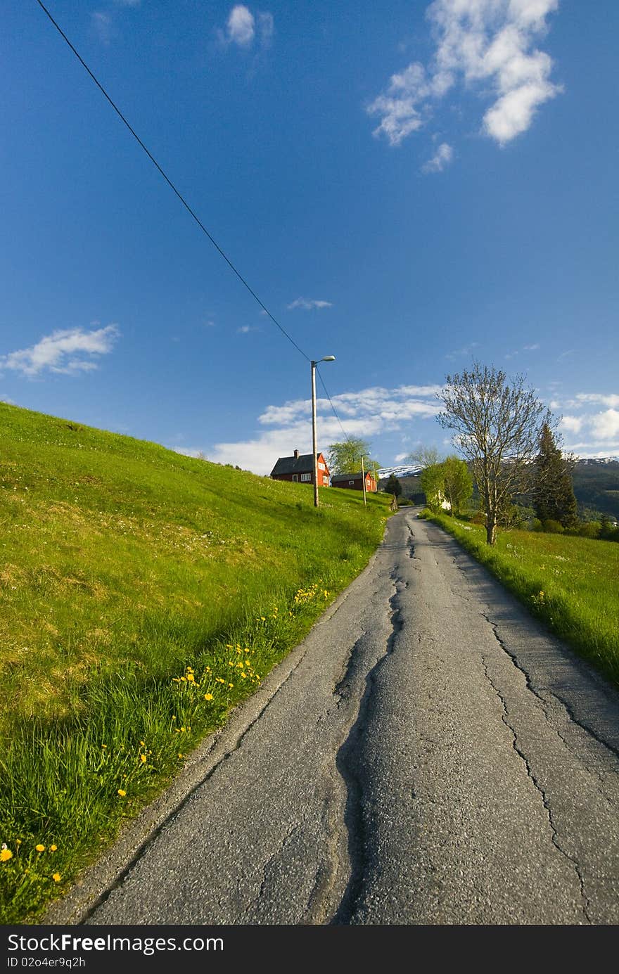 An aged road to the peace full hill village, alongside the grass hill at Vossevangen,  Norway