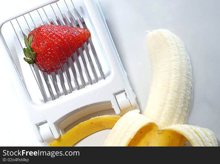 Slicing strawberries and bananas for breakfast. Slicing strawberries and bananas for breakfast.