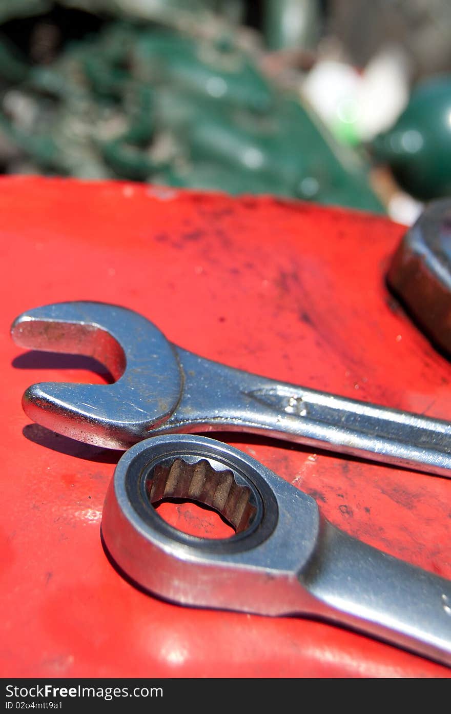 Detail of metal wrenches on old-timer tractor with part of engine. Detail of metal wrenches on old-timer tractor with part of engine