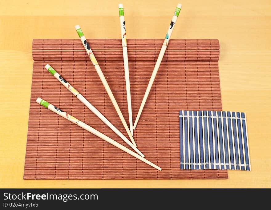 Decorative Designed Chopsticks On Red Bamboo. Decorative Designed Chopsticks On Red Bamboo