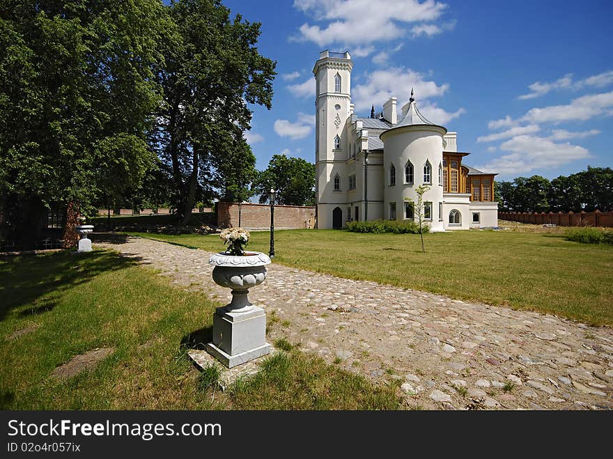 Gothic palace with the garden into a sunny day. Gothic palace with the garden into a sunny day