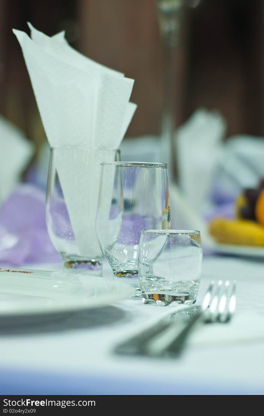 Three glasses on a wedding table and a fork. Three glasses on a wedding table and a fork.