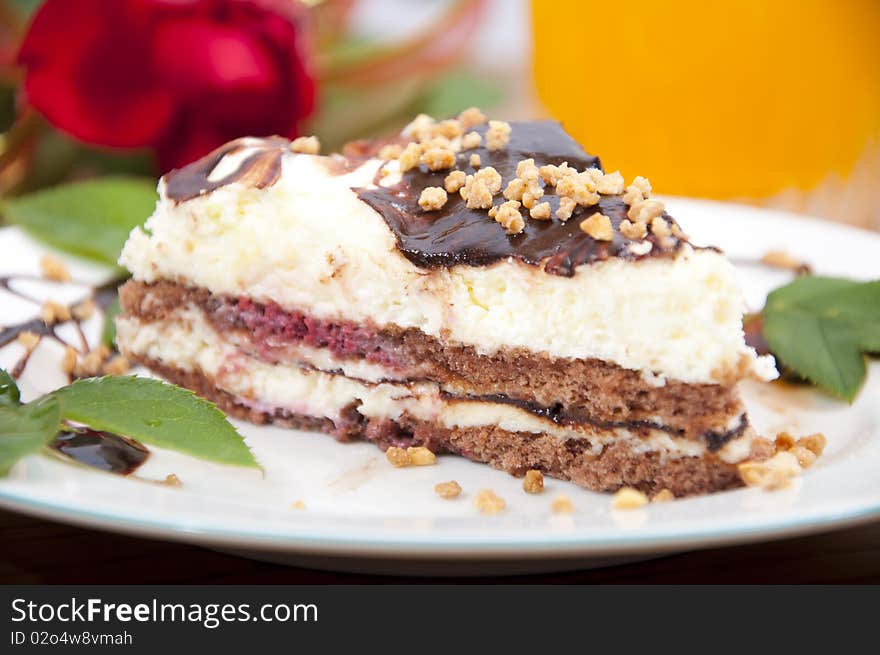 Sweet chocolate dessert with nuts in shape of triangle with juice