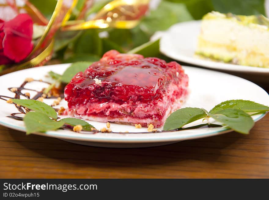 Sweet raspberry and strawberries dessert with chocolate on white plate