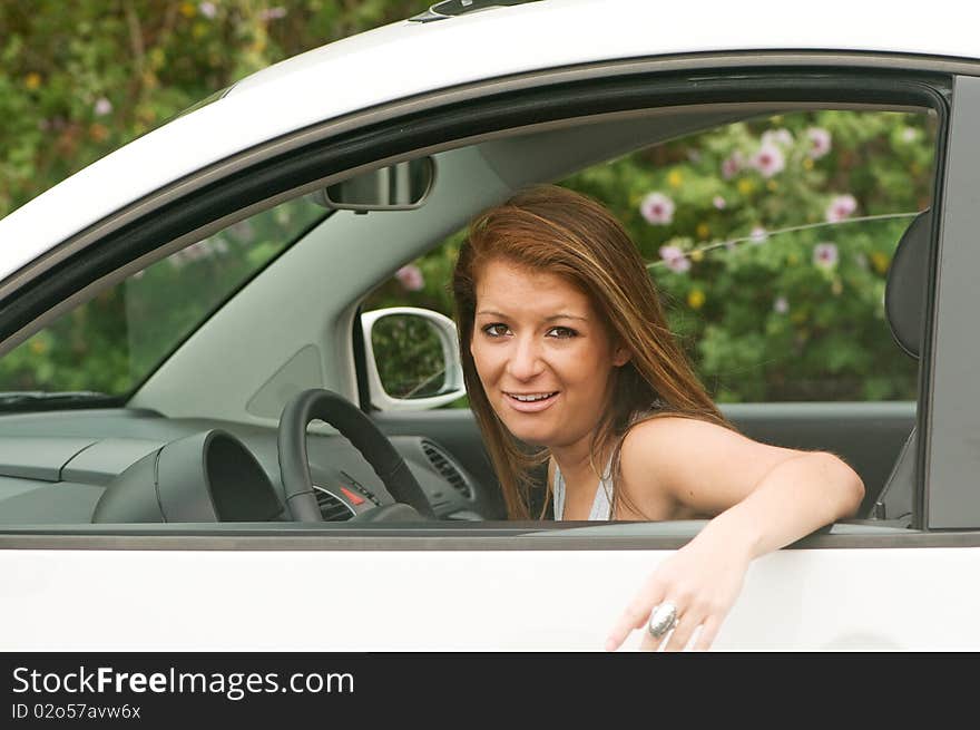 Teen girl driver in automobile looking out the window with a stressful expression. Teen girl driver in automobile looking out the window with a stressful expression