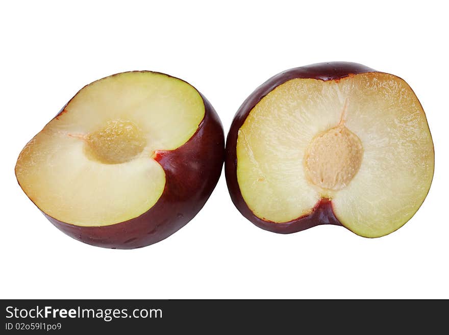 Plum cut fifty-fifty with pit on white background. Plum cut fifty-fifty with pit on white background