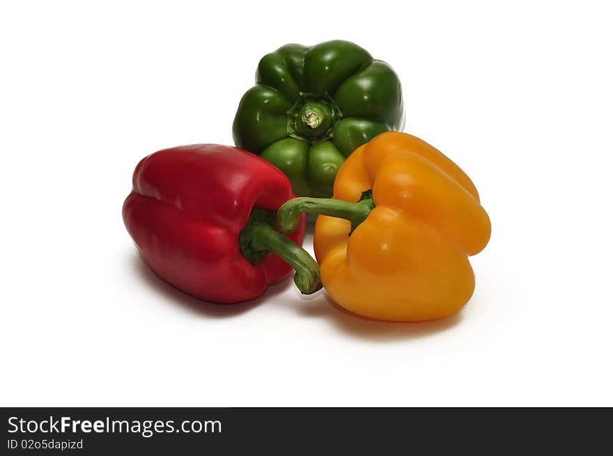 Three bell peppers isolated against a white background