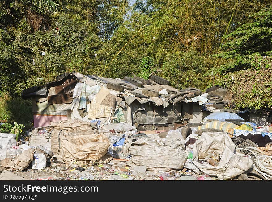 Sacks and sacks of garbage in front of a shanty