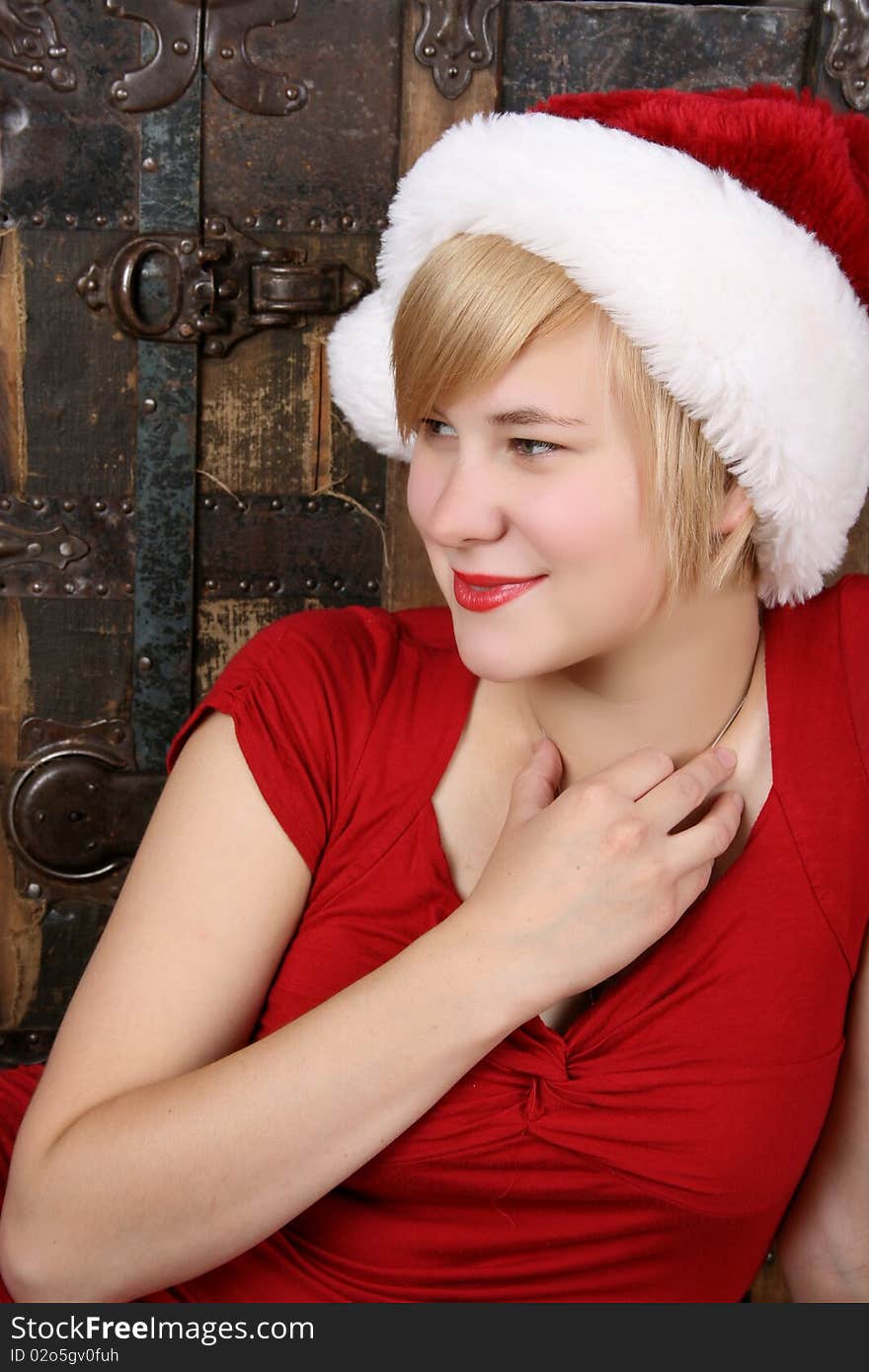 Beautiful young blond female wearing a fluffy christmas hat. Beautiful young blond female wearing a fluffy christmas hat