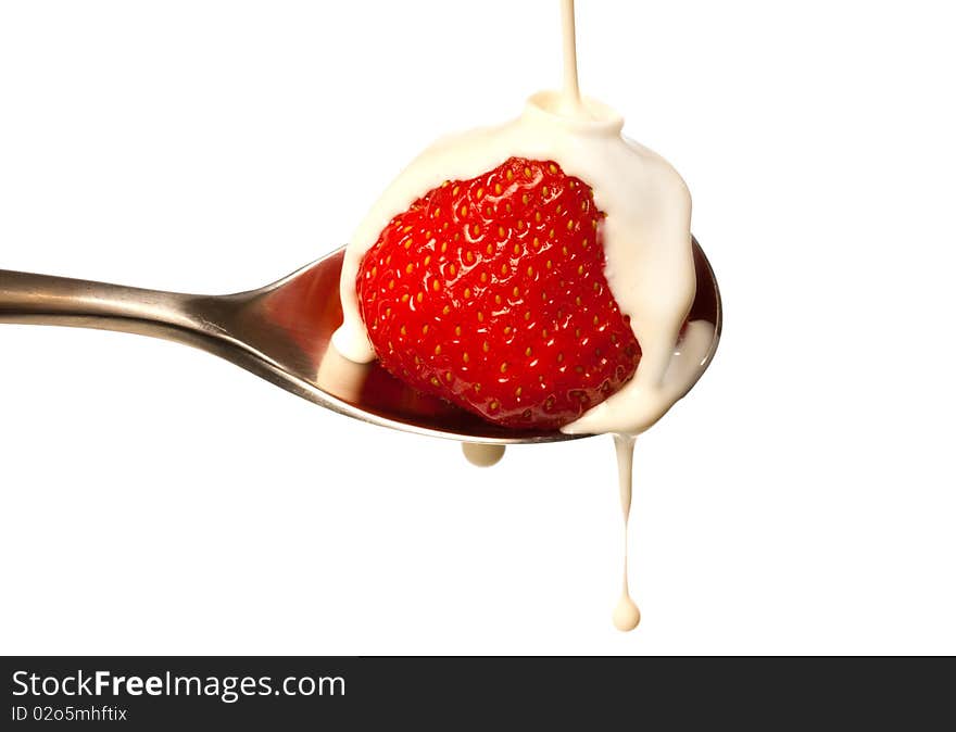 Strawberry with fresh cream being poured over it. Strawberry with fresh cream being poured over it.