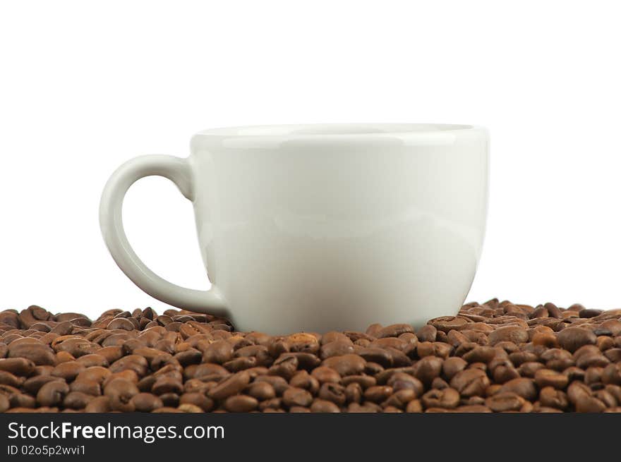 Coffee beans and a cup isolated on white background