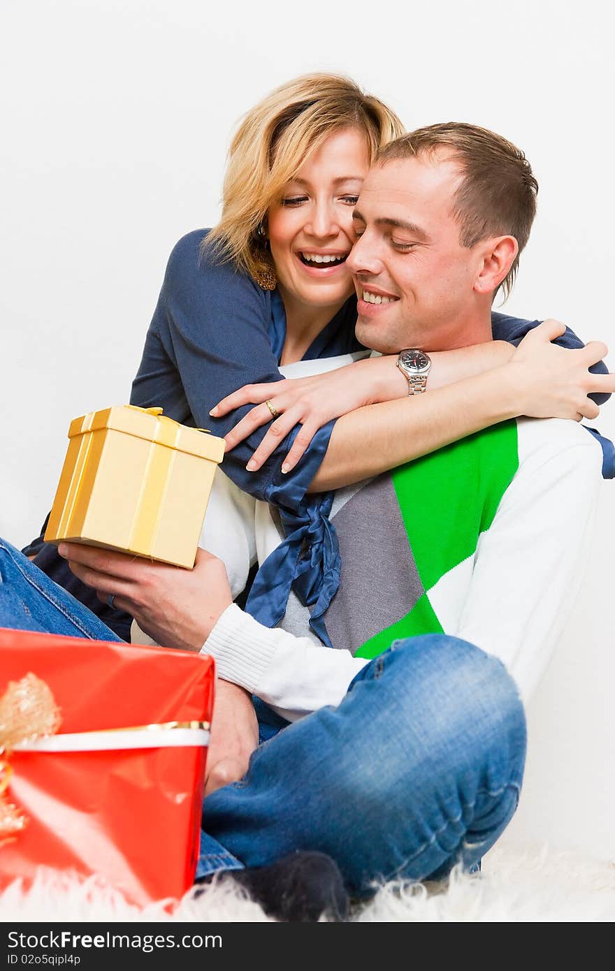 Young lovely happy couple embracing with presents. Young lovely happy couple embracing with presents