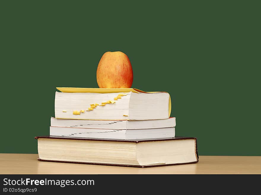 Stack of books  apple & green chalkboard