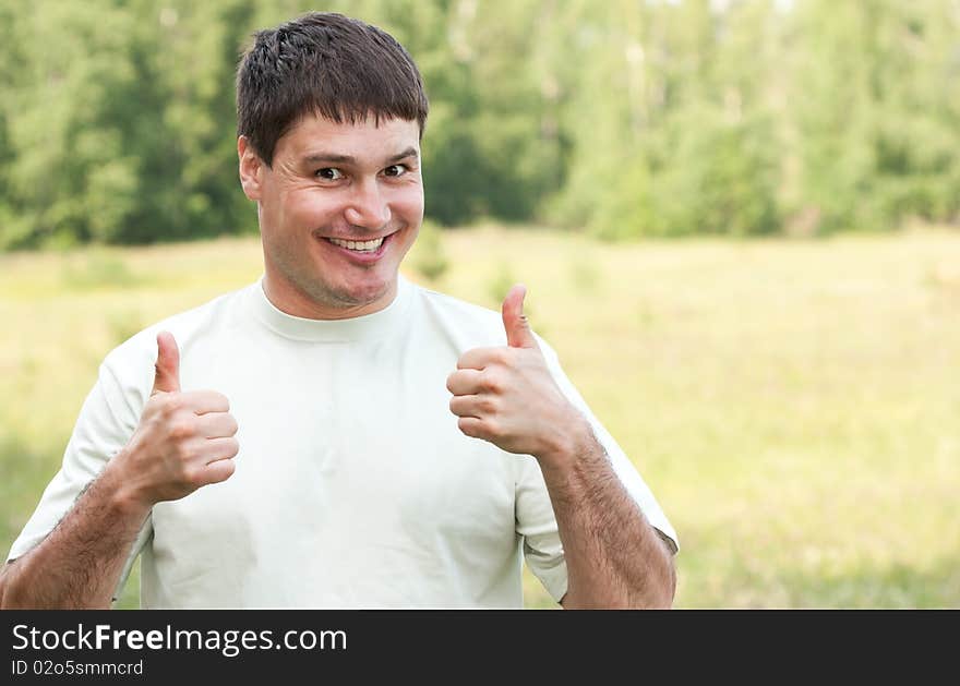 Man gives thumbs up on nature