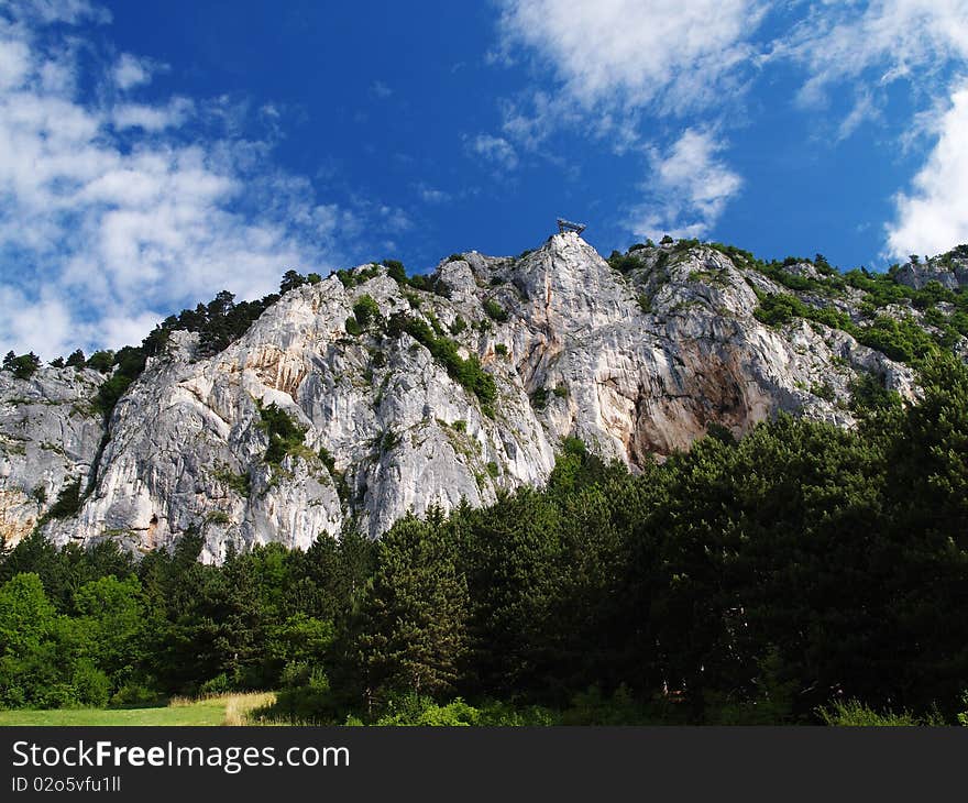 Amazing rock growing from forest with blue sky and clouds. Idela climbing area. Amazing rock growing from forest with blue sky and clouds. Idela climbing area.