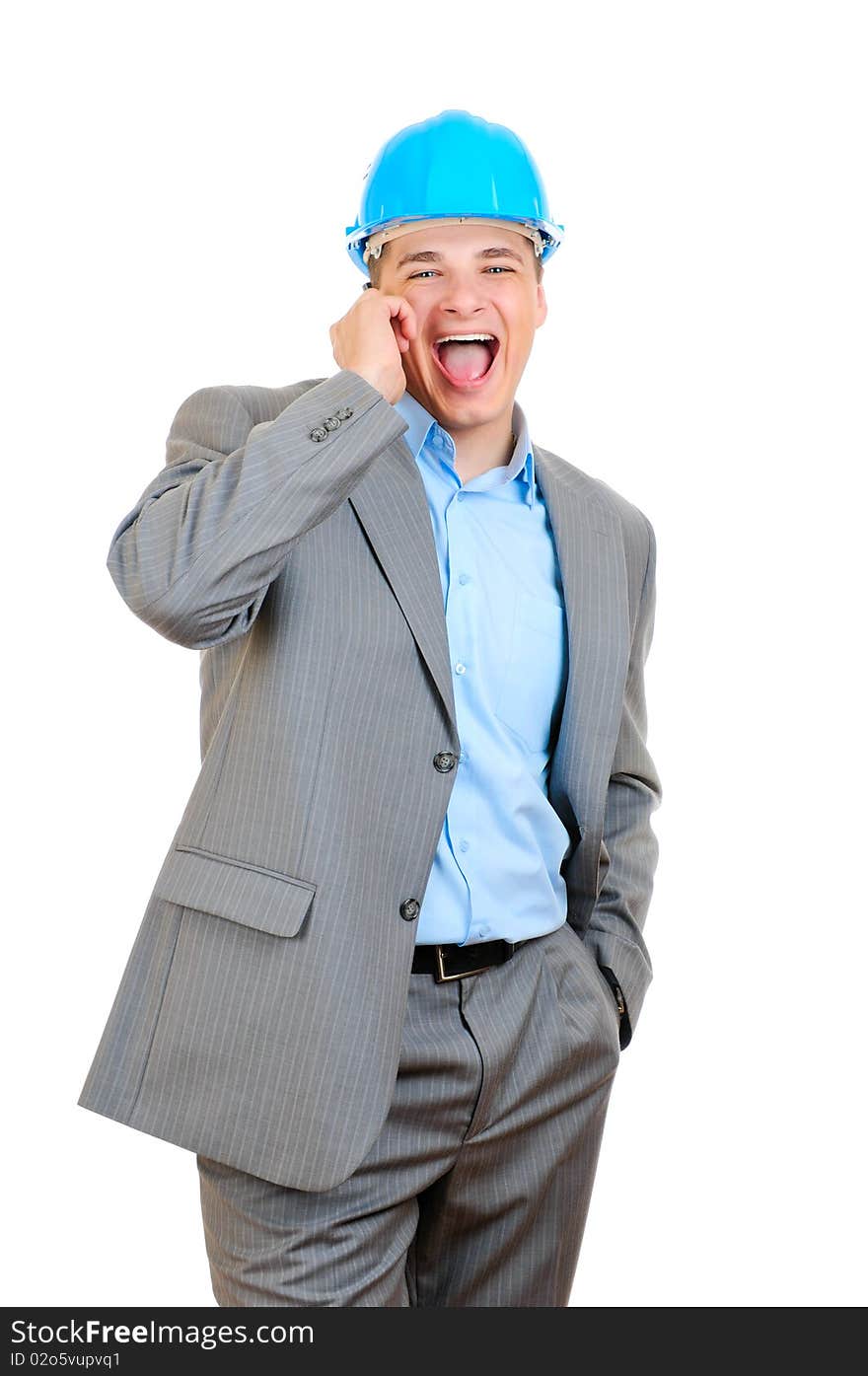 Cheerful engineer ih blue hard hat talking  over the phone. Cheerful engineer ih blue hard hat talking  over the phone