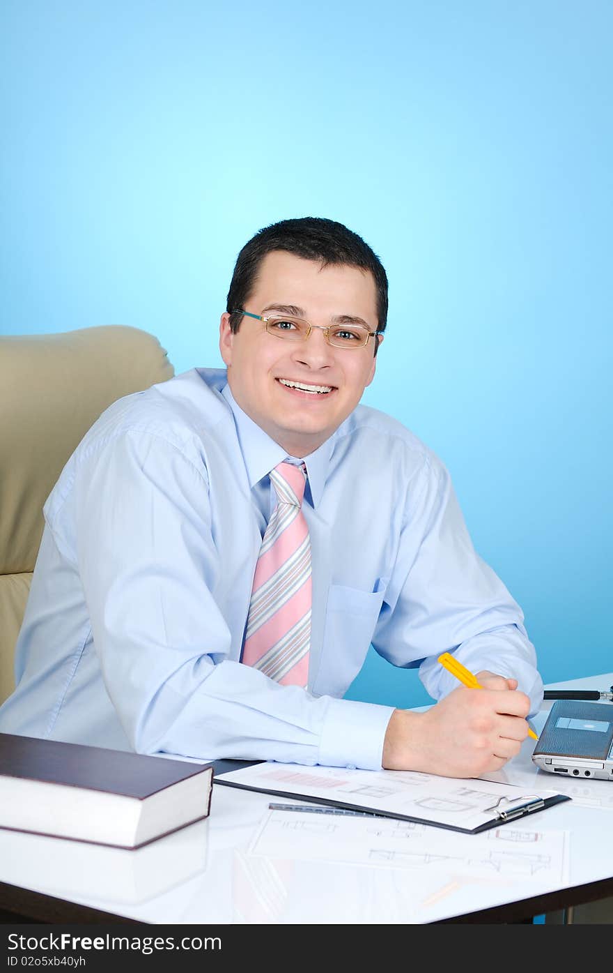 Businessman at work. On blue background.