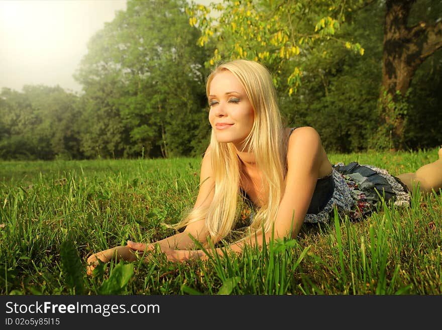 Beautiful woman lying on the grass. Beautiful woman lying on the grass