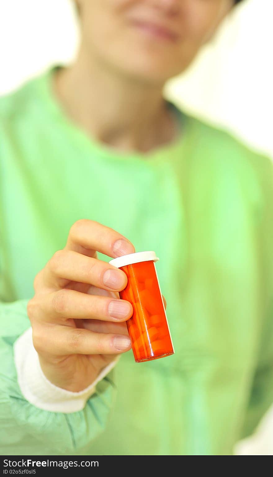 Doctor holding bottle of prescription pills with hand