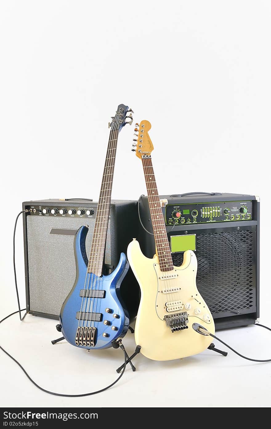 Guitars and amplifiers inside on studio on white background