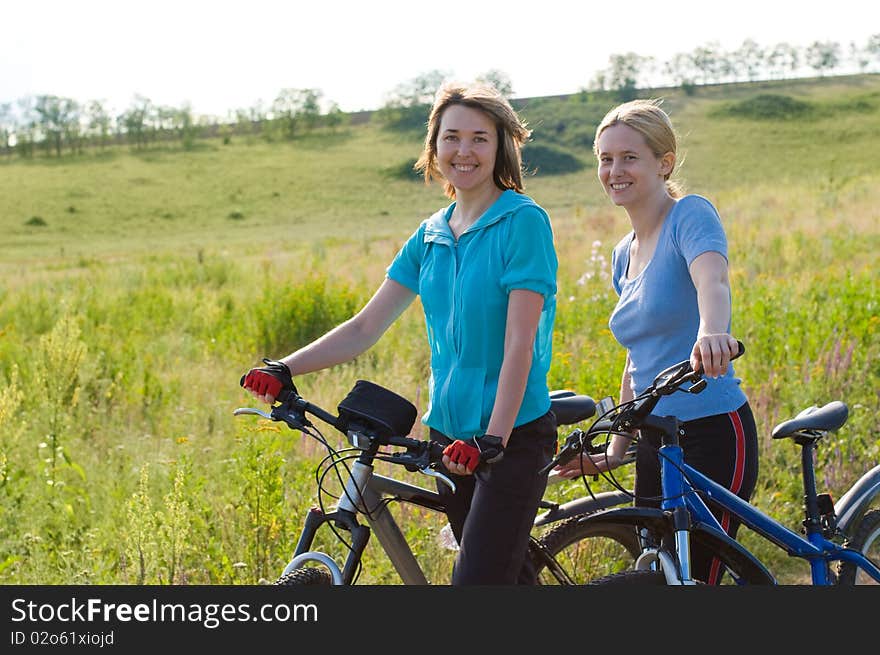 Two cyclists relax biking outdoors