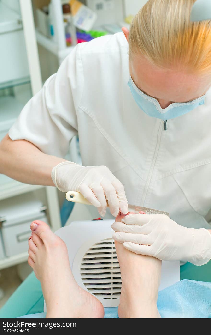 People at work.Pedicure in process