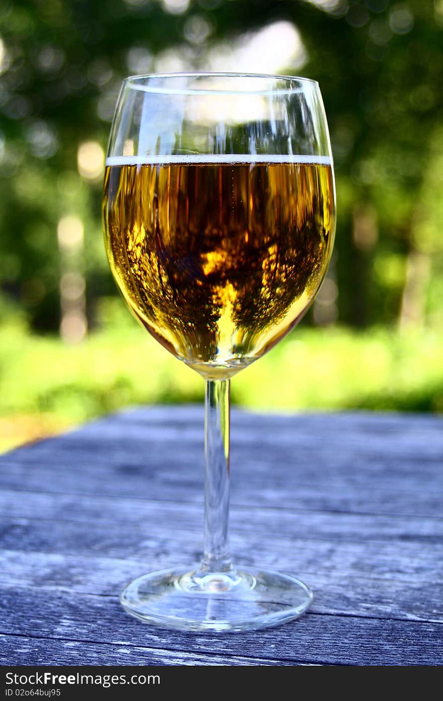 Glass of cold dutch beer, outside in a summer garden