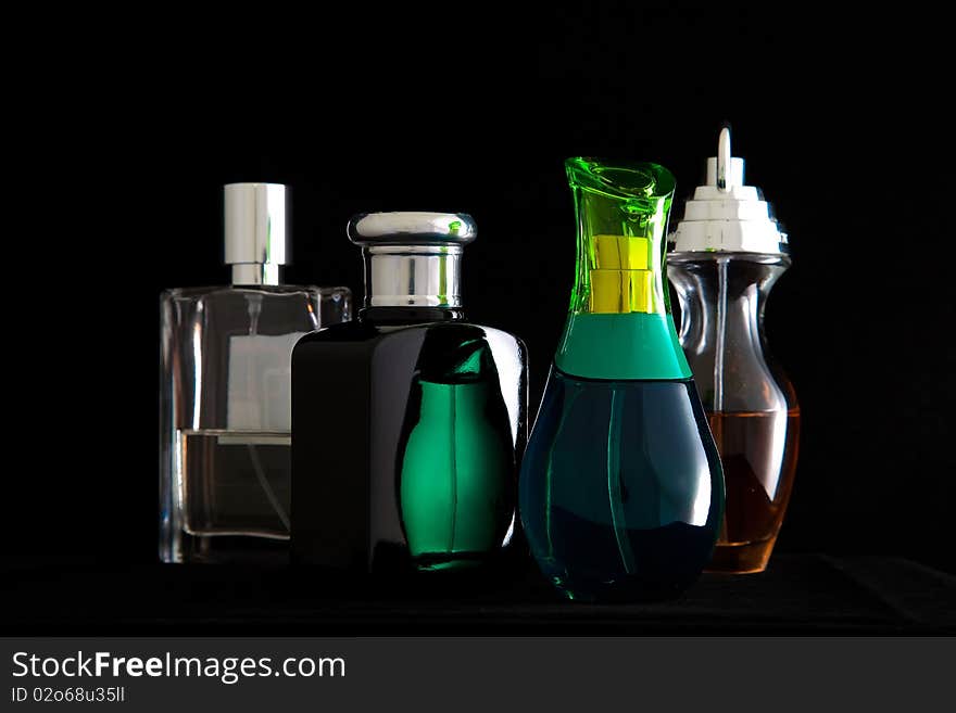 Small perfume bottles arranged on a table. Small perfume bottles arranged on a table.