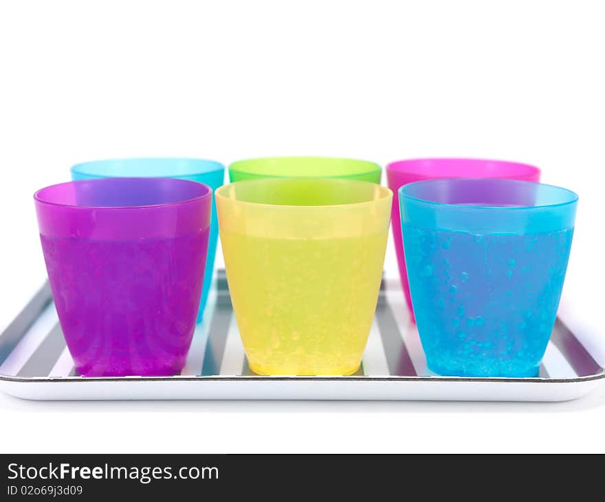 Plastic cups filled with carbonated water isolated against a white background. Plastic cups filled with carbonated water isolated against a white background