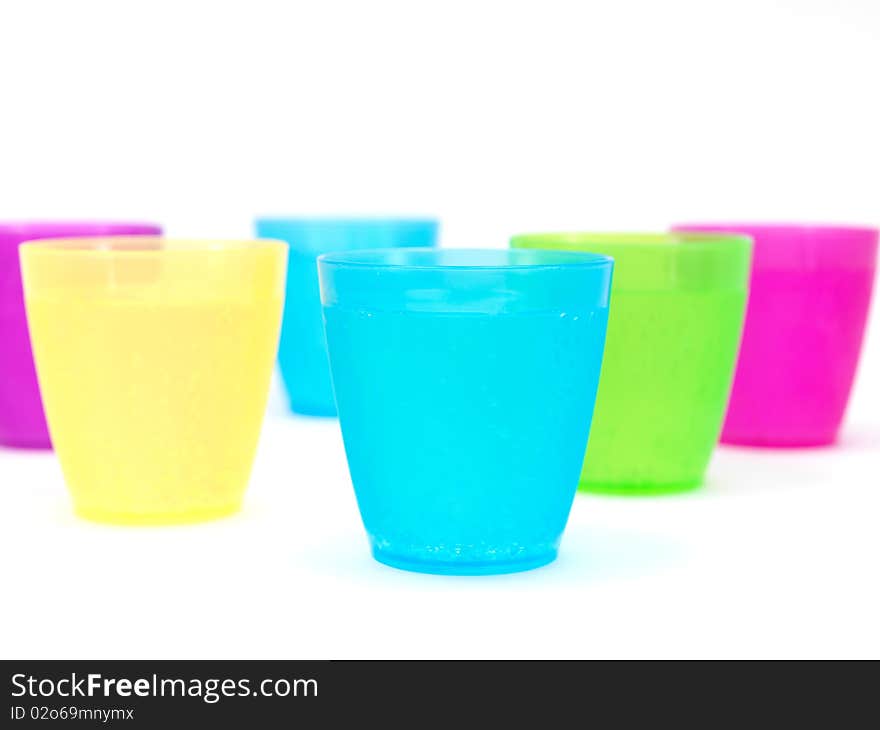 Plastic cups filled with carbonated water isolated against a white background. Plastic cups filled with carbonated water isolated against a white background