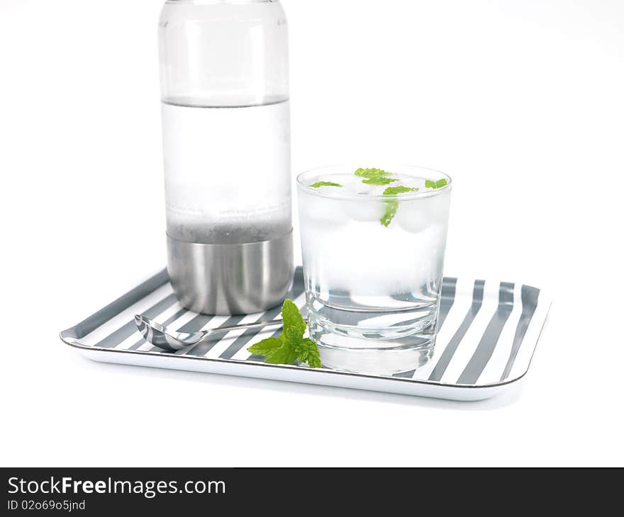 Mint flavoured carbonated water on a serving tray isolated against a white background. Mint flavoured carbonated water on a serving tray isolated against a white background