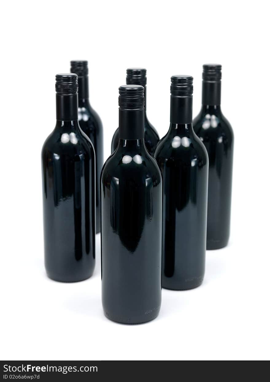 Bottles of red wine isolated against a white background. Bottles of red wine isolated against a white background