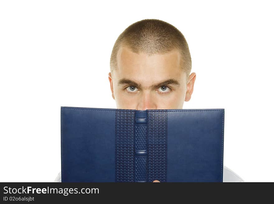 Portrait of a young man holding a blue notebook on white background