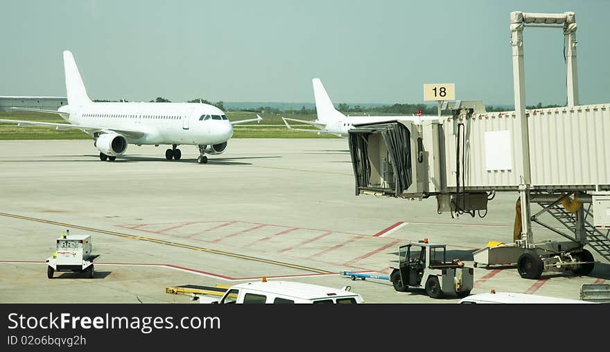 Tow airplanes approaching airport gates