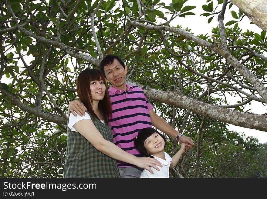 Portrait of a happy Asian family at a park